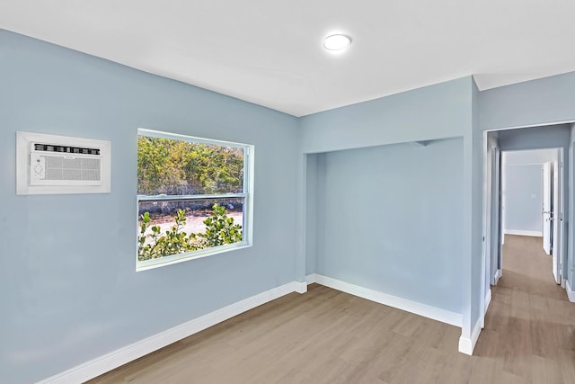 interior space with an AC wall unit and light hardwood / wood-style flooring