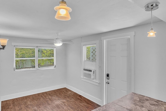 entrance foyer with ceiling fan, cooling unit, and dark wood-type flooring