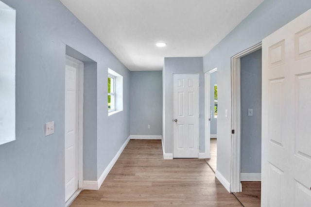 hallway with light hardwood / wood-style flooring