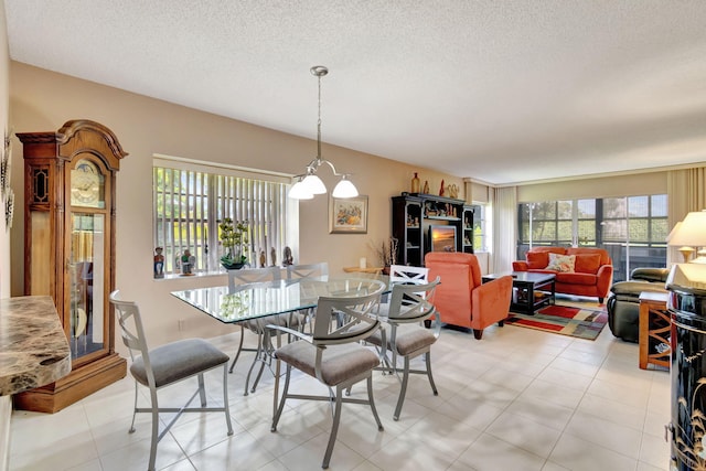 dining space with a notable chandelier and a textured ceiling