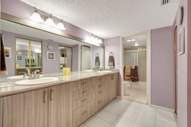 full bathroom featuring vanity, shower / bath combination with curtain, a textured ceiling, toilet, and tile patterned floors