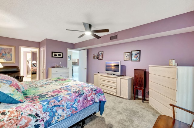 carpeted bedroom with a textured ceiling, ceiling fan, and a closet