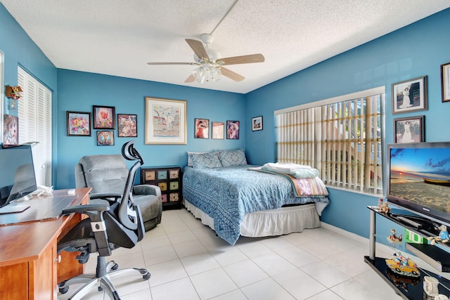 tiled bedroom with multiple windows, a textured ceiling, and ceiling fan