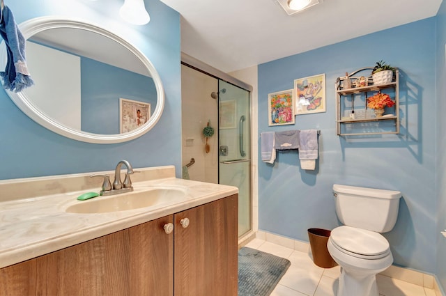 bathroom with vanity, tile patterned floors, a shower with shower door, and toilet