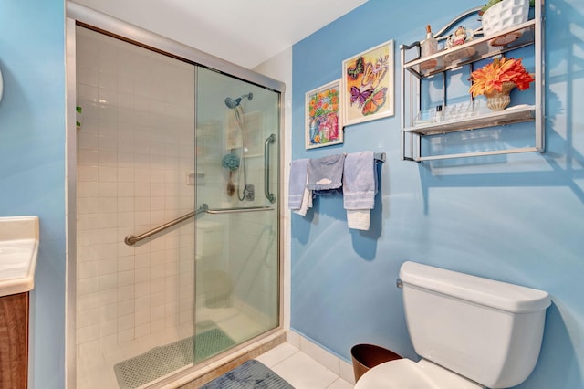 bathroom with vanity, tile patterned flooring, toilet, and an enclosed shower