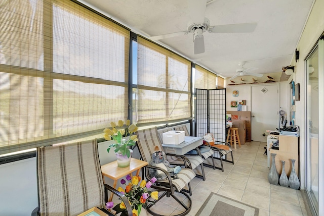 sunroom / solarium featuring ceiling fan