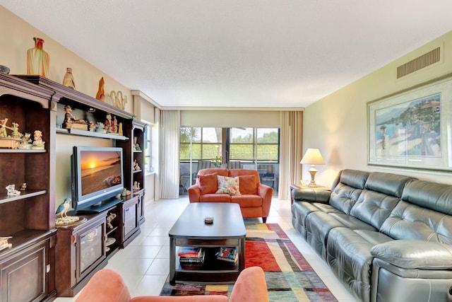 tiled living room featuring a textured ceiling