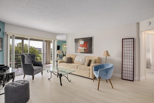 living room with light wood-type flooring and a textured ceiling