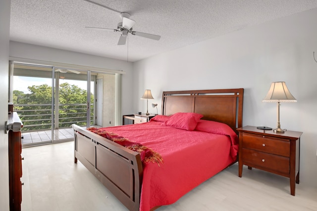 bedroom featuring ceiling fan, access to exterior, and a textured ceiling