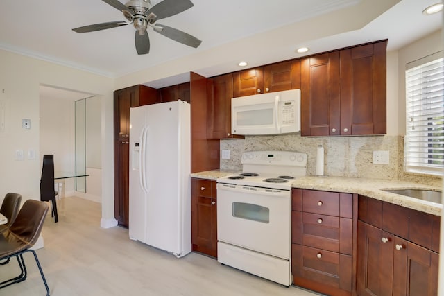 kitchen featuring light wood-type flooring, white appliances, backsplash, ornamental molding, and ceiling fan