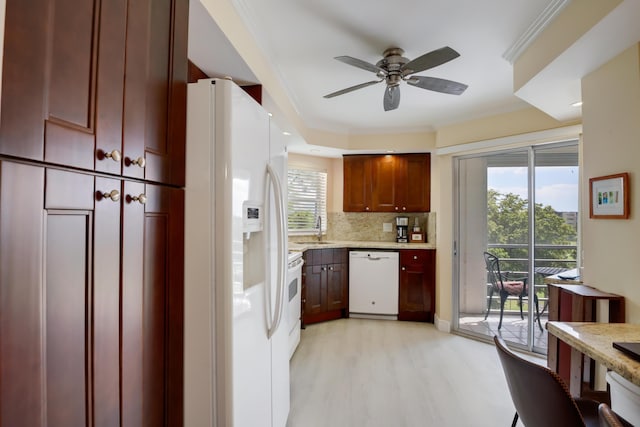 kitchen with a sink, decorative backsplash, white appliances, ceiling fan, and light wood finished floors