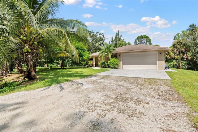 view of front of home featuring a front yard and a garage