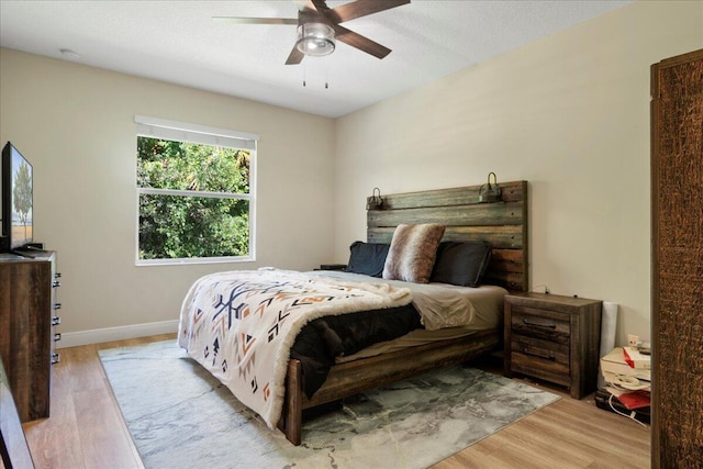 bedroom featuring light hardwood / wood-style flooring and ceiling fan