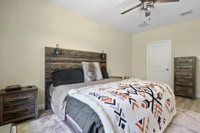 bedroom with ceiling fan and light hardwood / wood-style floors