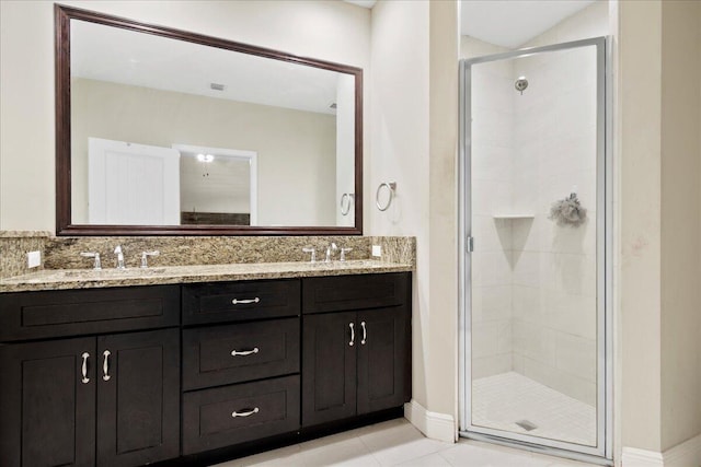 bathroom featuring tile patterned flooring, walk in shower, and vanity