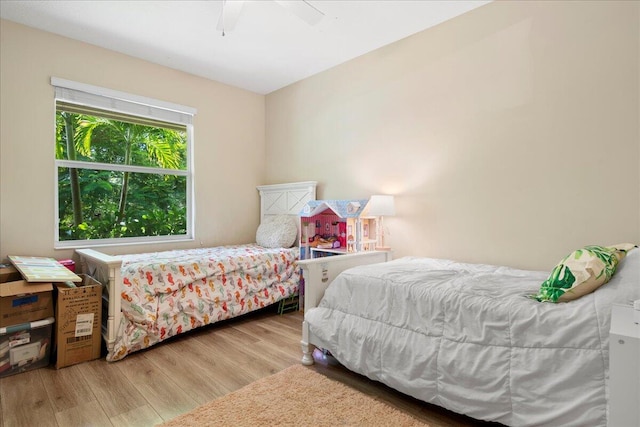 bedroom with light hardwood / wood-style flooring and ceiling fan