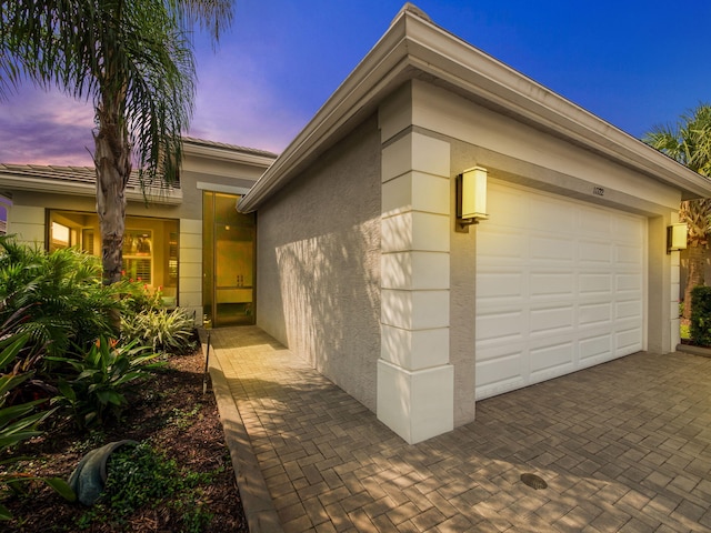 property exterior at dusk with a garage