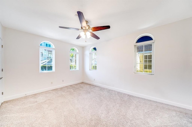 empty room with ceiling fan and light colored carpet