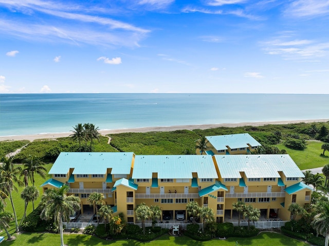 birds eye view of property featuring a beach view and a water view