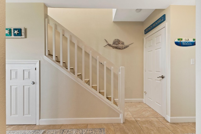 staircase featuring tile patterned floors