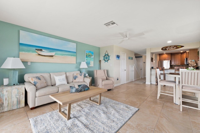 tiled living room with ceiling fan