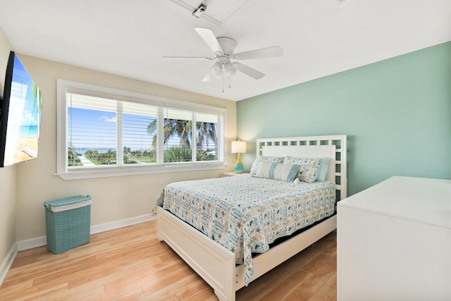 bedroom with ceiling fan, light wood-type flooring, and rail lighting