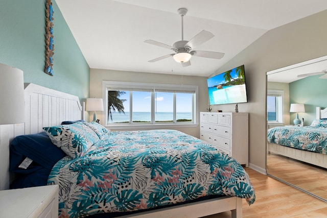 bedroom with multiple windows, lofted ceiling, light wood-type flooring, and ceiling fan