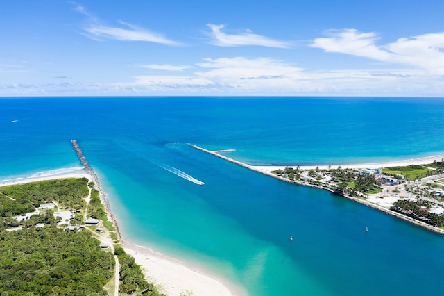 birds eye view of property featuring a water view and a beach view