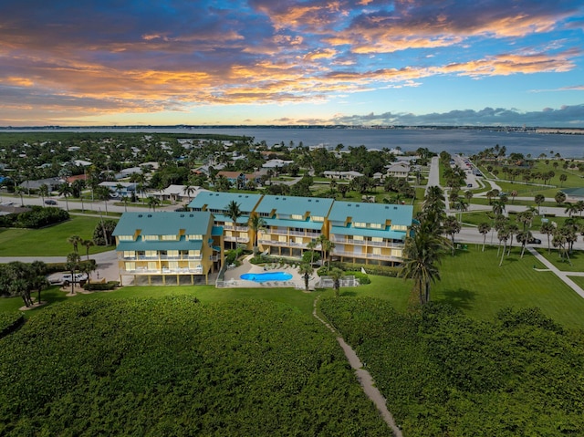 aerial view at dusk with a water view