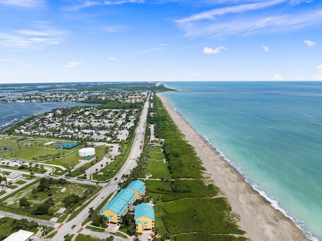 drone / aerial view featuring a water view and a beach view