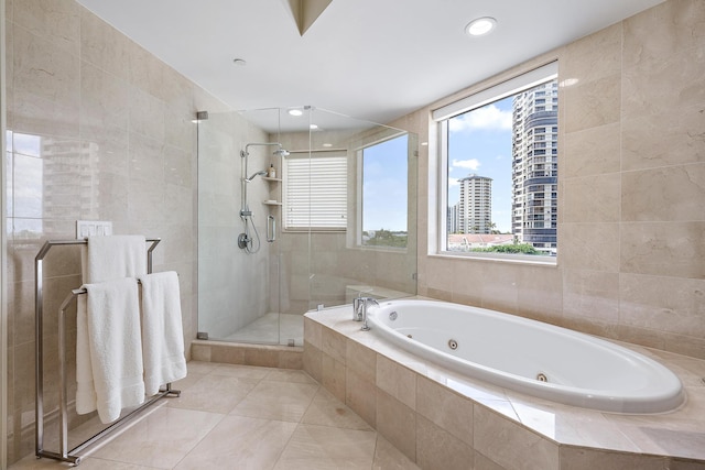 bathroom featuring tile patterned flooring, tile walls, and shower with separate bathtub