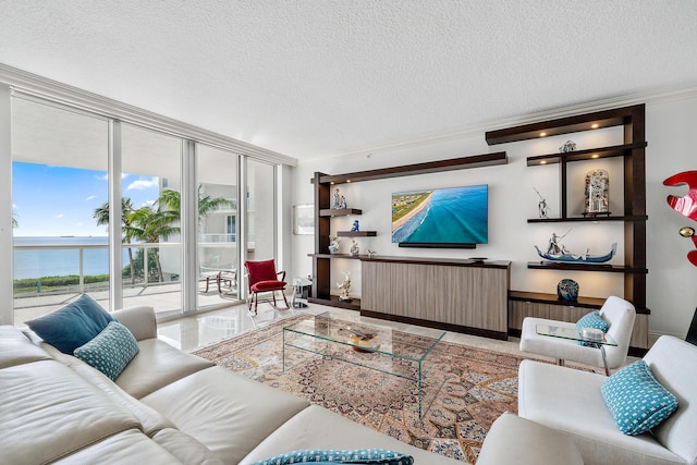 living room featuring a textured ceiling, floor to ceiling windows, a water view, and crown molding