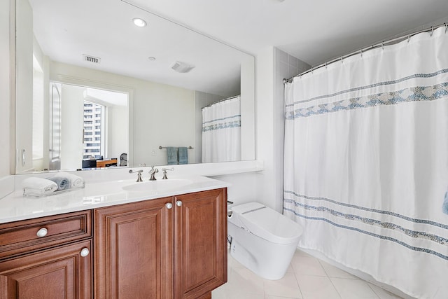 bathroom featuring tile patterned flooring, vanity, toilet, and walk in shower