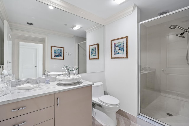 bathroom featuring ornamental molding, vanity, a shower with shower door, and toilet