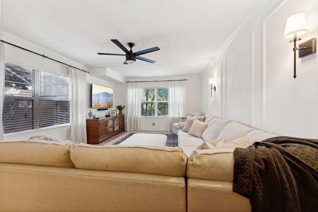 living room with crown molding and ceiling fan