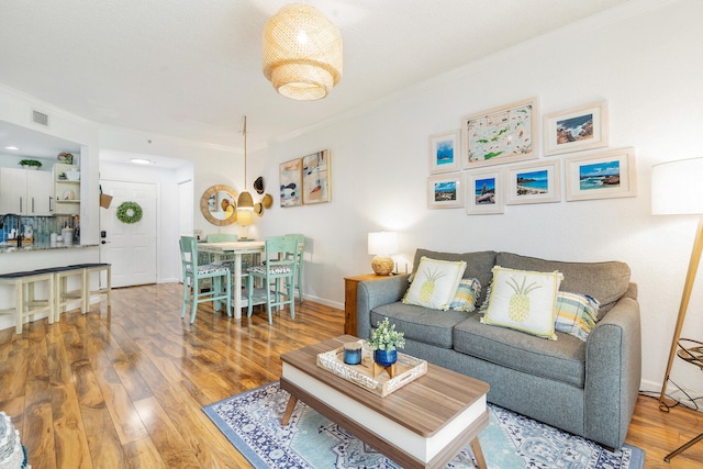 living room featuring crown molding and hardwood / wood-style floors