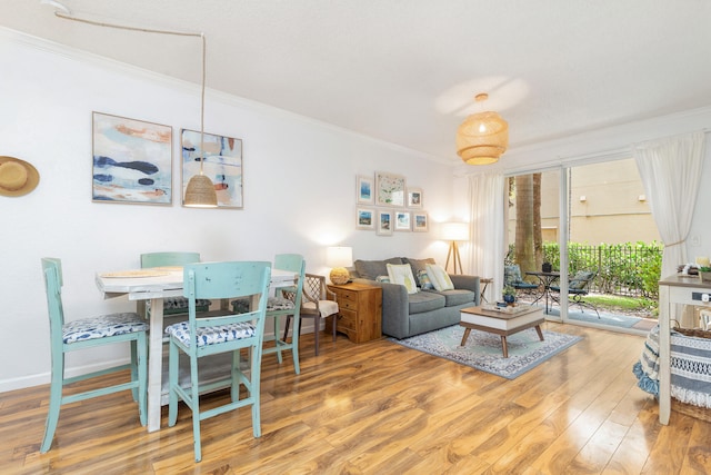 living room with ornamental molding and wood-type flooring