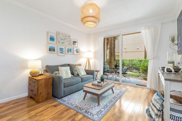 living room with ornamental molding, a textured ceiling, and hardwood / wood-style floors