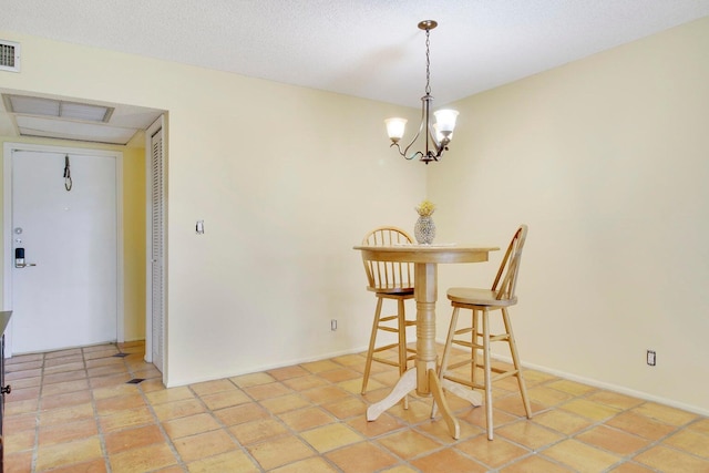 dining area featuring a notable chandelier