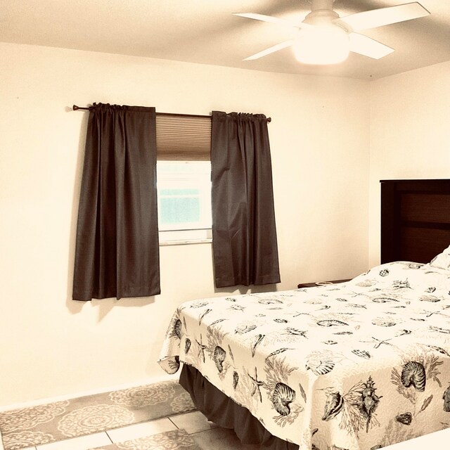 bedroom featuring ceiling fan and light tile patterned flooring