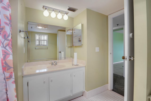 bathroom featuring tile patterned flooring, vanity, and a shower with curtain