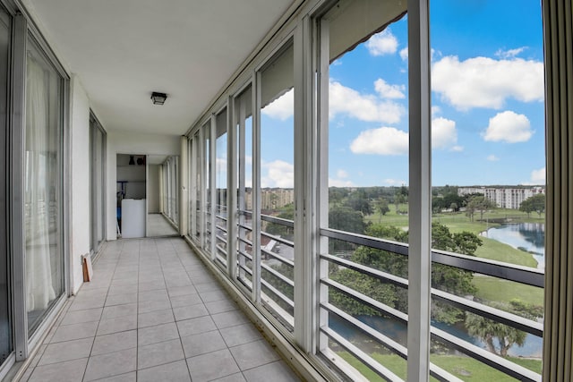 unfurnished sunroom featuring a water view