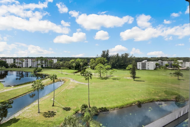 view of community featuring a lawn and a water view