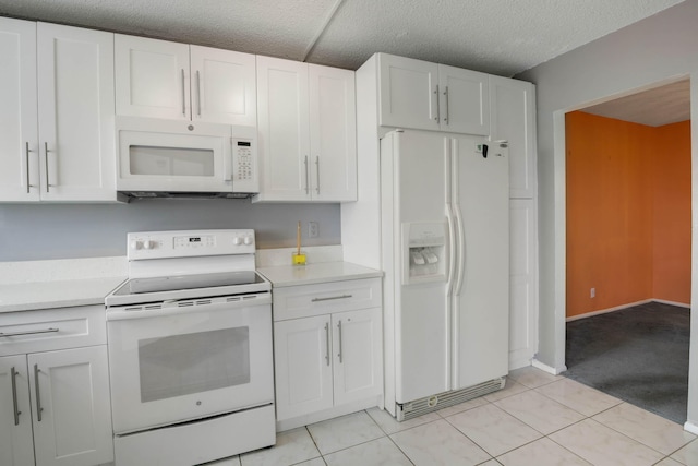 kitchen with a textured ceiling, white appliances, light tile patterned floors, and white cabinets