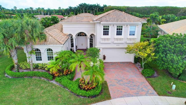 mediterranean / spanish-style house with a garage and a front yard