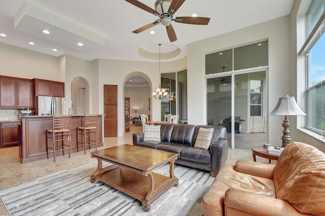9772 Via Grandezza W, Wellington, FL 33411 - living area featuring arched walkways, a towering ceiling, recessed lighting, ceiling fan with notable chandelier, and light tile patterned floors