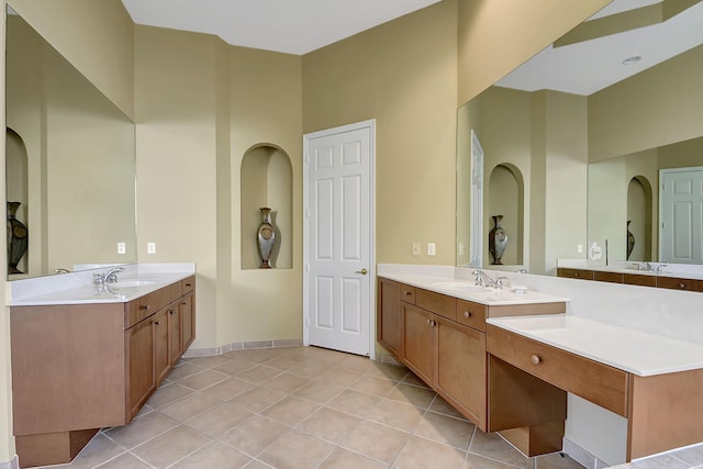 9772 Via Grandezza W, Wellington, FL 33411 - bathroom featuring tile patterned floors, baseboards, a sink, and two vanities