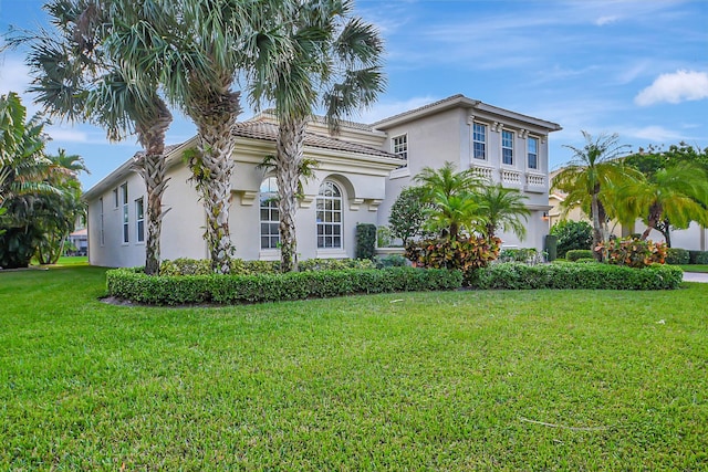 9772 Via Grandezza W, Wellington, FL 33411 - mediterranean / spanish-style house with a tile roof, a front yard, and stucco siding