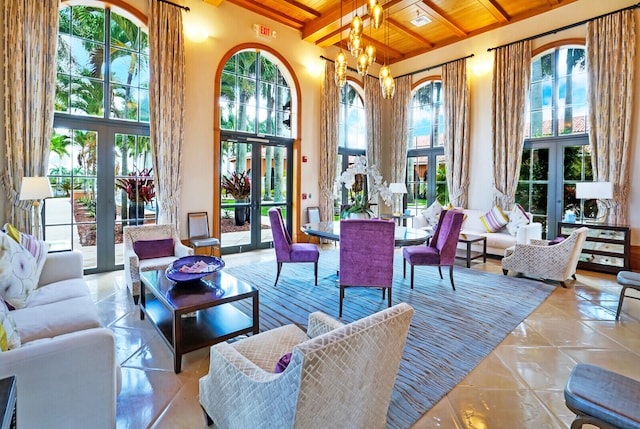 living room featuring wood ceiling, a wealth of natural light, and french doors