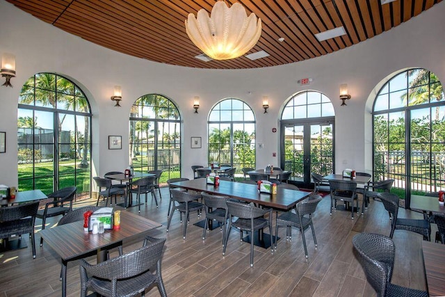 dining area with wooden ceiling, a wealth of natural light, and hardwood / wood-style flooring